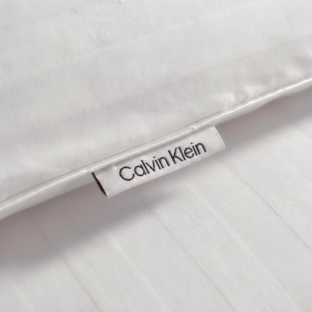 Calvin Klein folded compressed comforter showing vacuum-sealed shipping and compact storage benefit