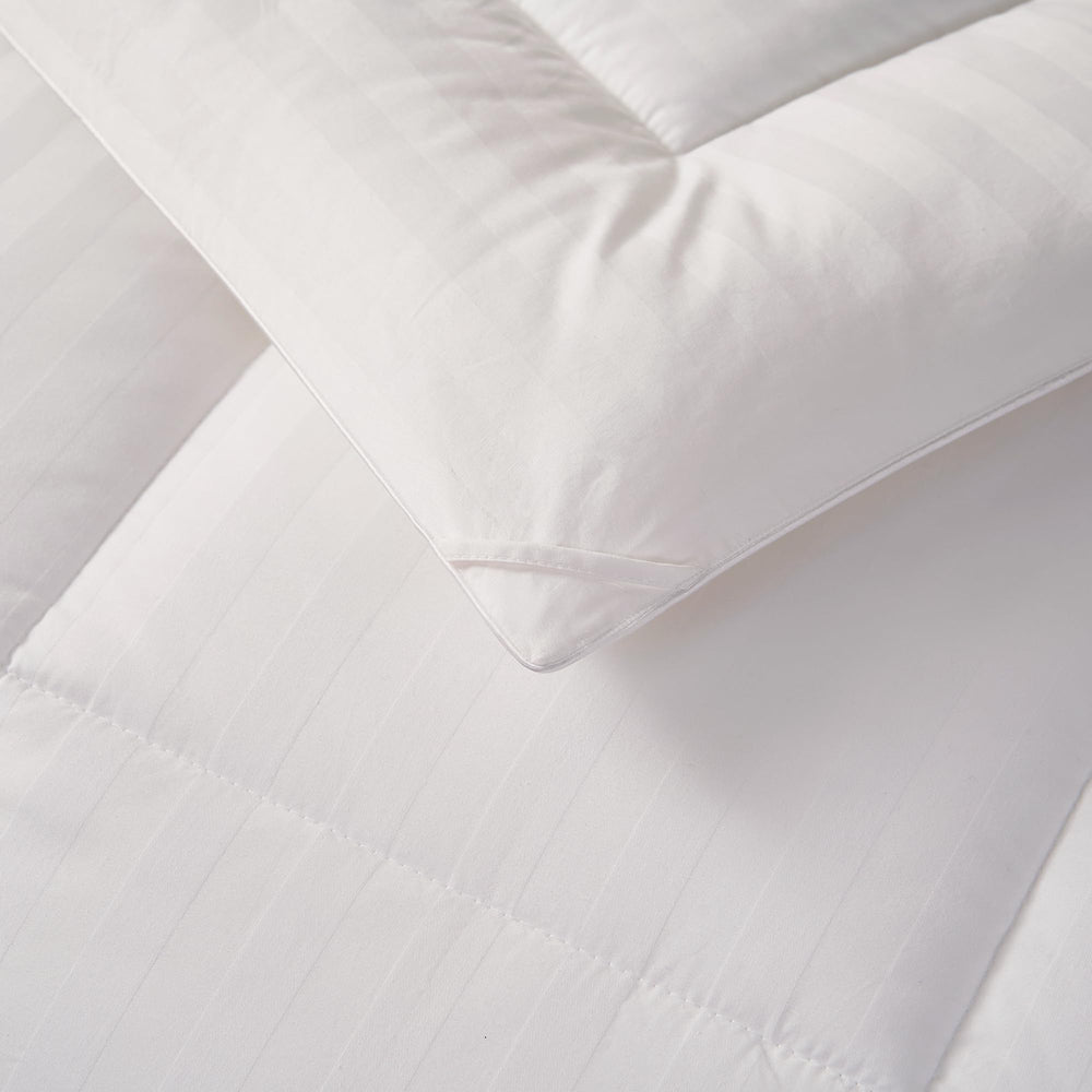 Calvin Klein comforter in styled bedroom showing designer aesthetic and cozy atmosphere benefit
