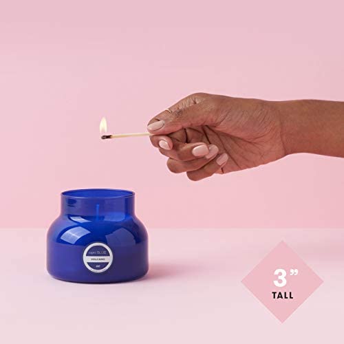 Capri Blue candle lit in bathroom offering bright fragrance and relaxing vibe