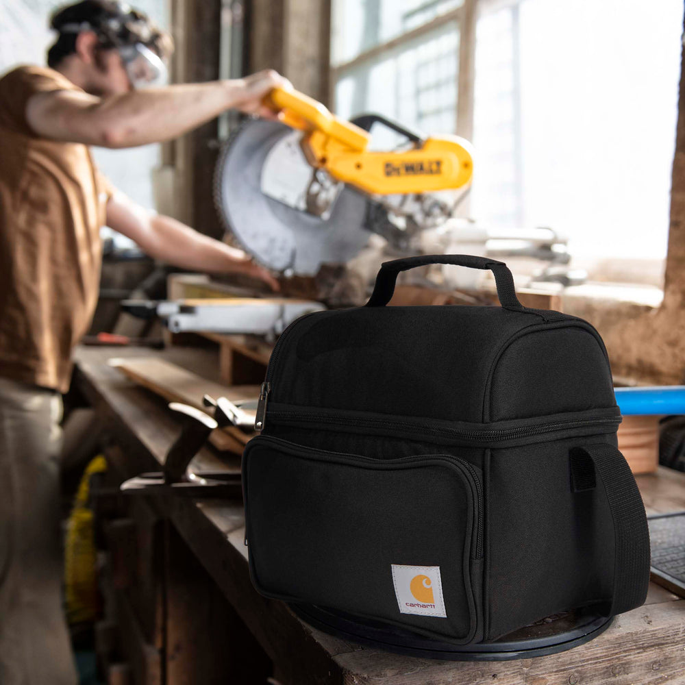 Carhartt next to water bottle showing compact scale and capacity