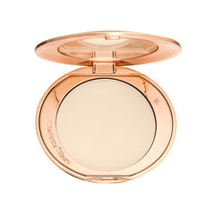 Charlotte Tilbury compact front packaging showing sleek design and travel convenience