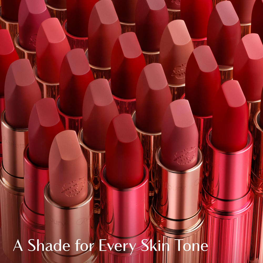 Charlotte Tilbury lipstick in hand demonstrating one-swipe coverage benefit