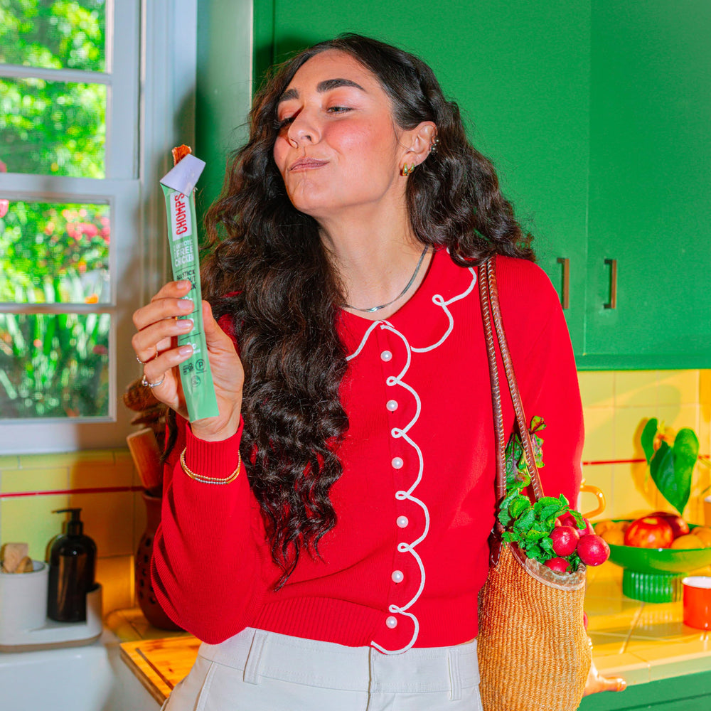 Chomps sticks in backpack illustrating portable, trail-ready snack convenience