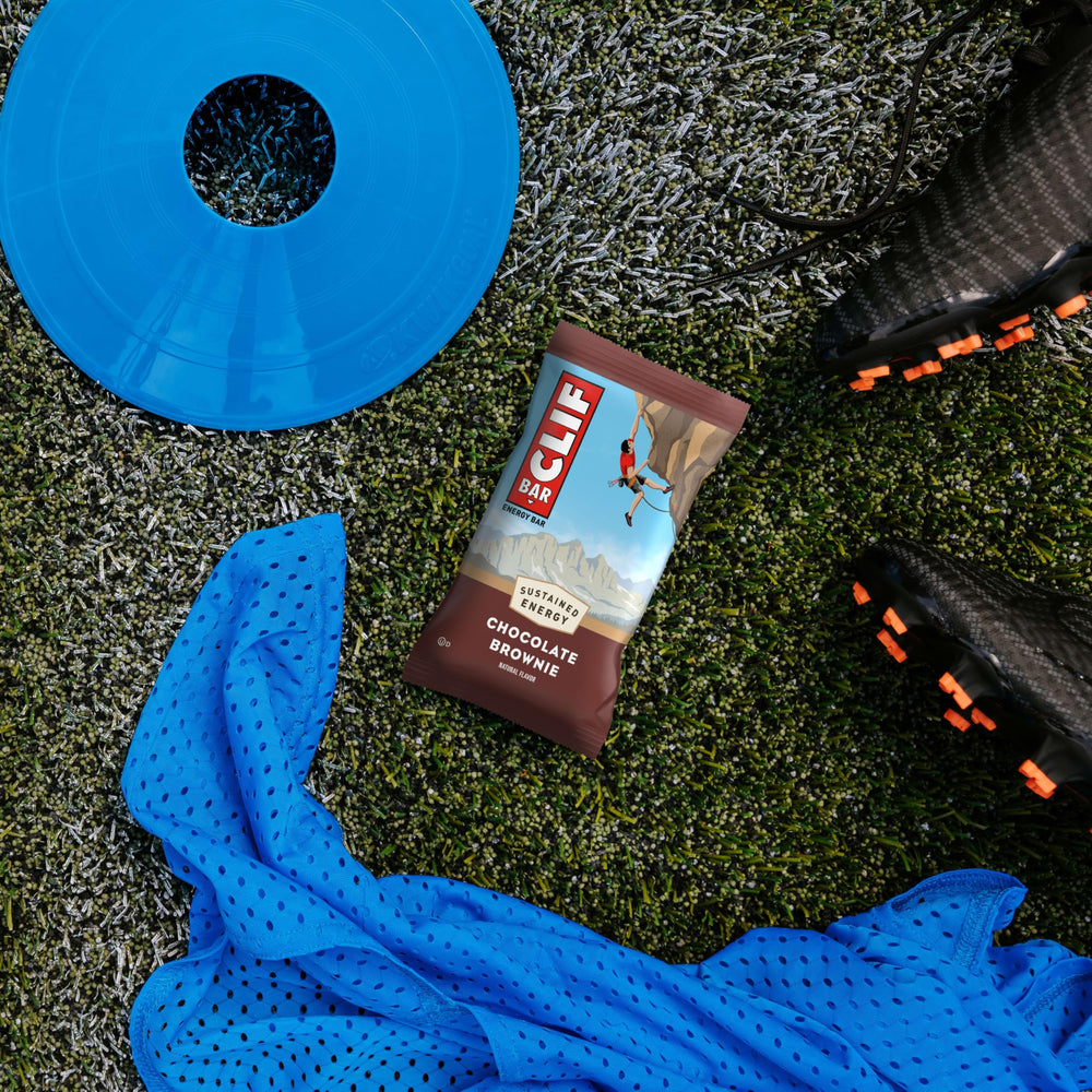 CLIF Bar beside a backpack conveying packable fuel for hikes and rides