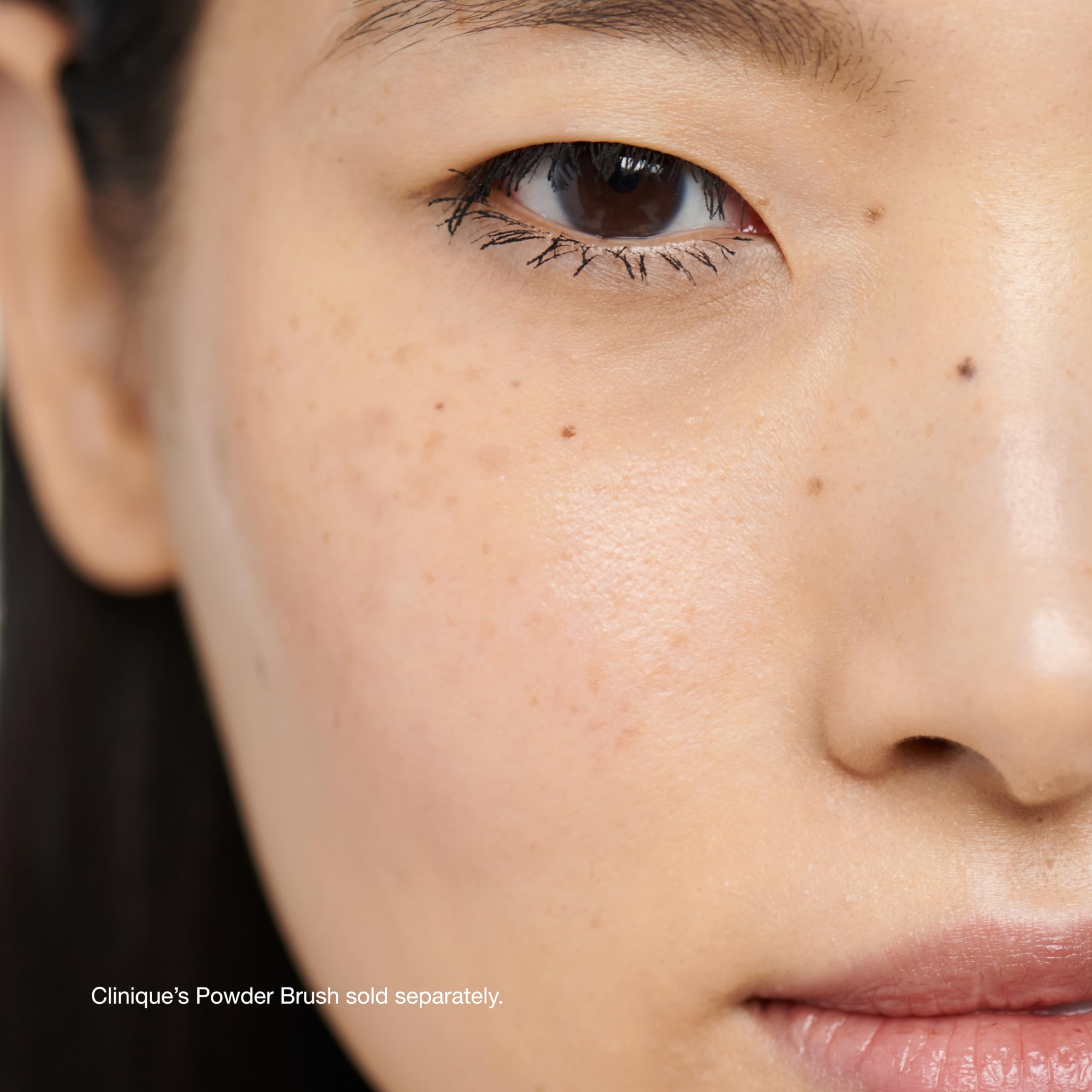 Clinique puff applying powder for even coverage and crease-preventing benefit