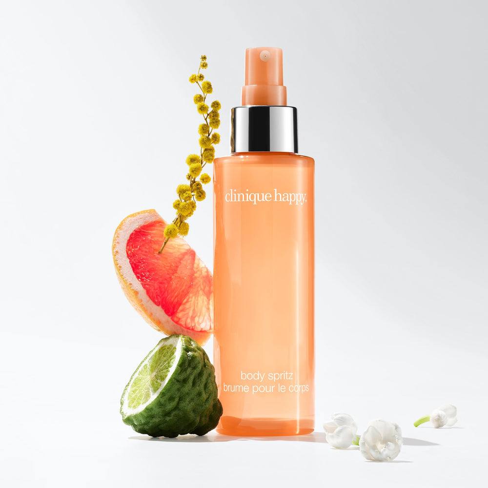 Hand spraying Clinique Happy Body Spritz for instant refresh and portability benefit