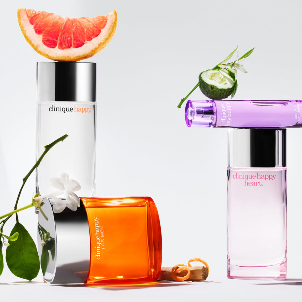 Clinique Happy bottle staged with grapefruit and flowers benefit: communicates bright, floral scent