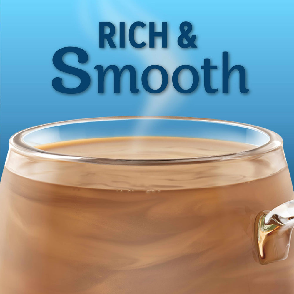 Coffee mate spoonful of creamer being added to coffee for fast blending