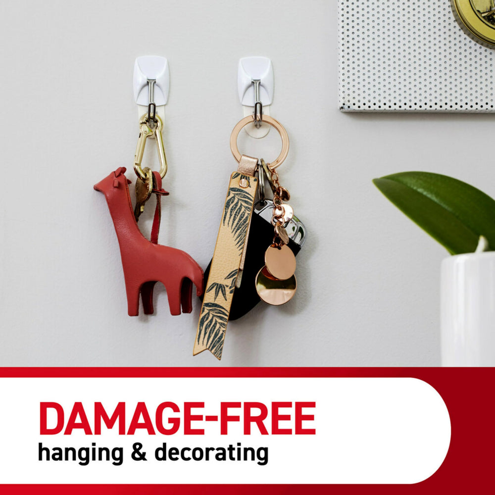Command hooks in a bedroom helping tidy accessories and maximize space