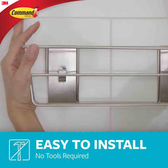 Command caddy mounted on glass shower illustrating secure hold benefit