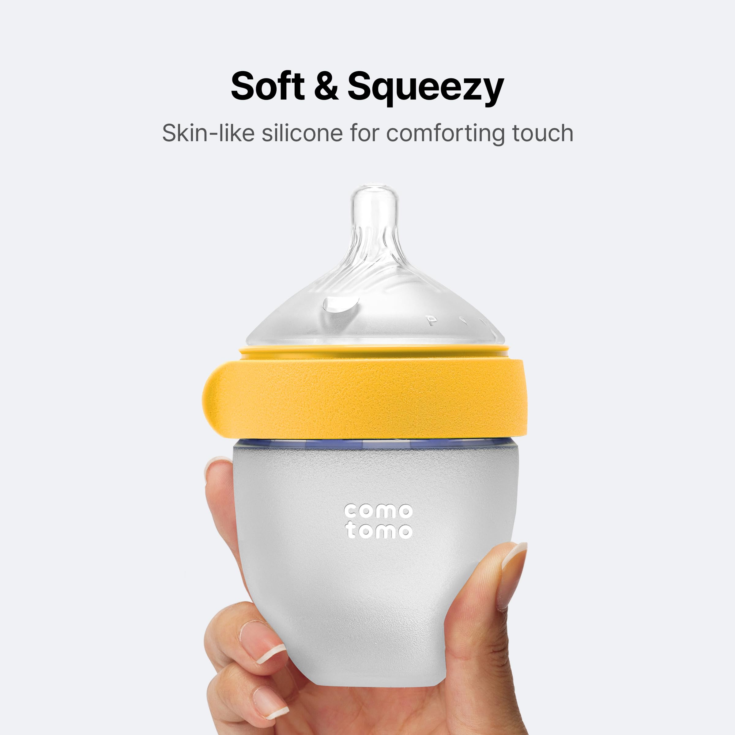 Comotomo size comparison with hand showing newborn-friendly 5oz capacity