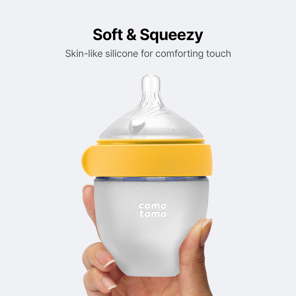 Comotomo size comparison with hand showing newborn-friendly 5oz capacity