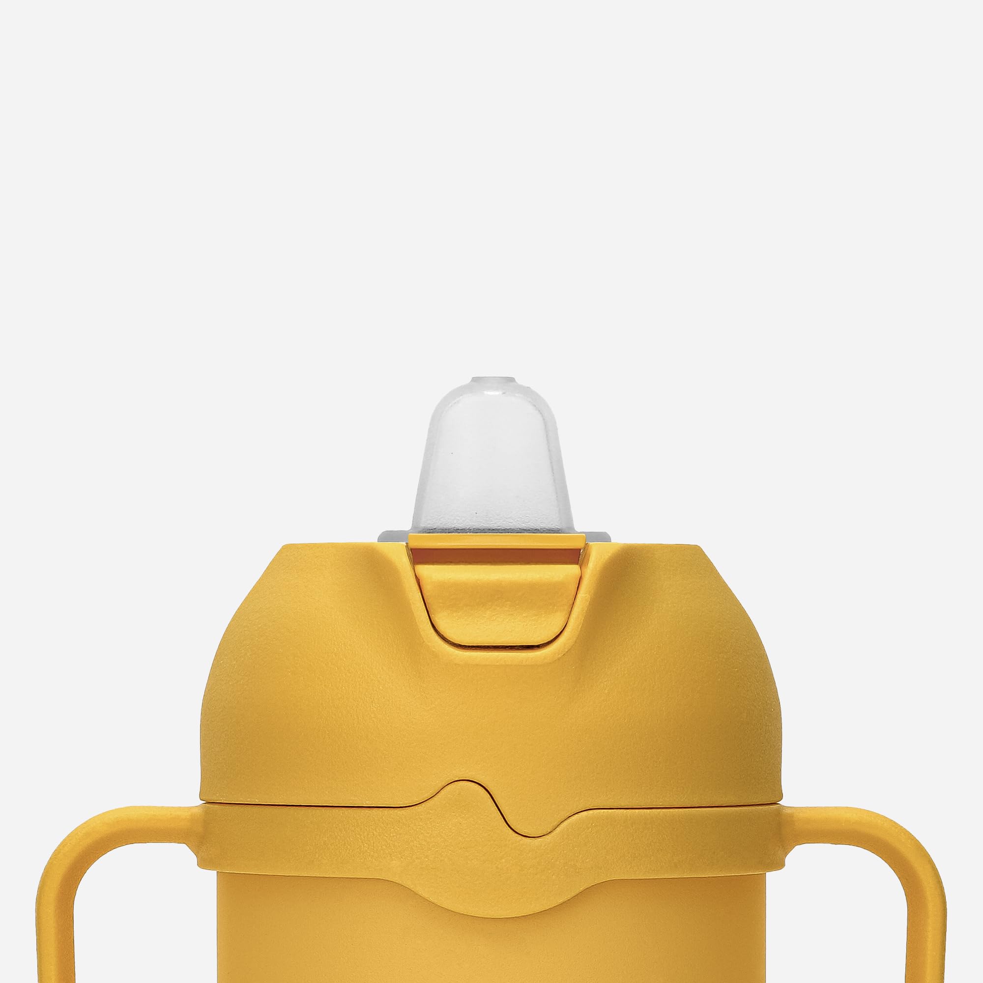 Comotomo tumbler handle detail highlighting self-orienting grip for easier toddler holding
