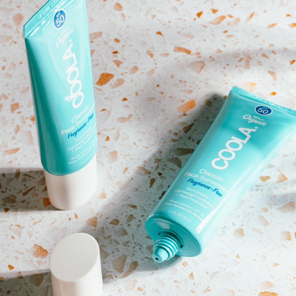 COOLA reef-compliant badge indicating environmentally conscious sunscreen choice