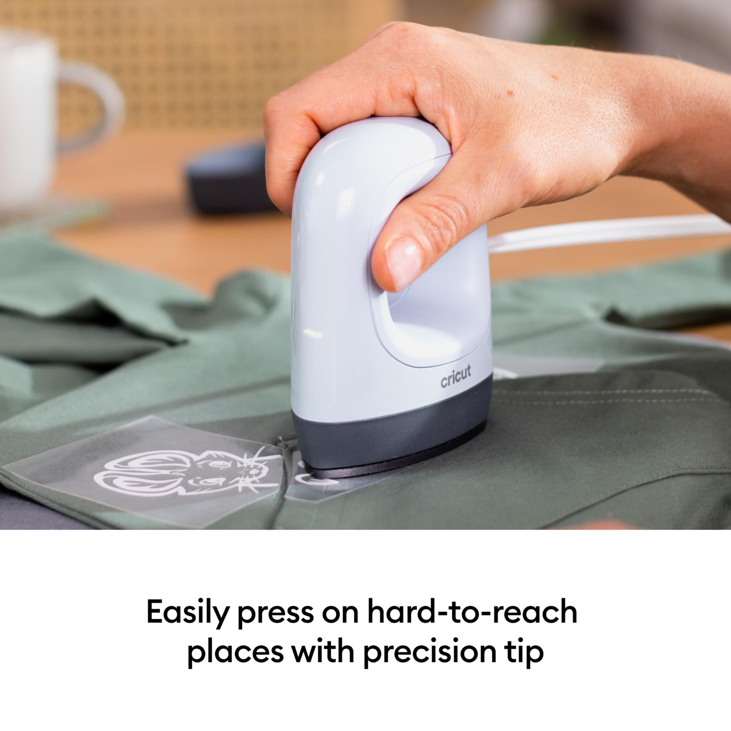 Cricut EasyPress Mini in use on baby onesie demonstrating gentle press for delicate fabrics