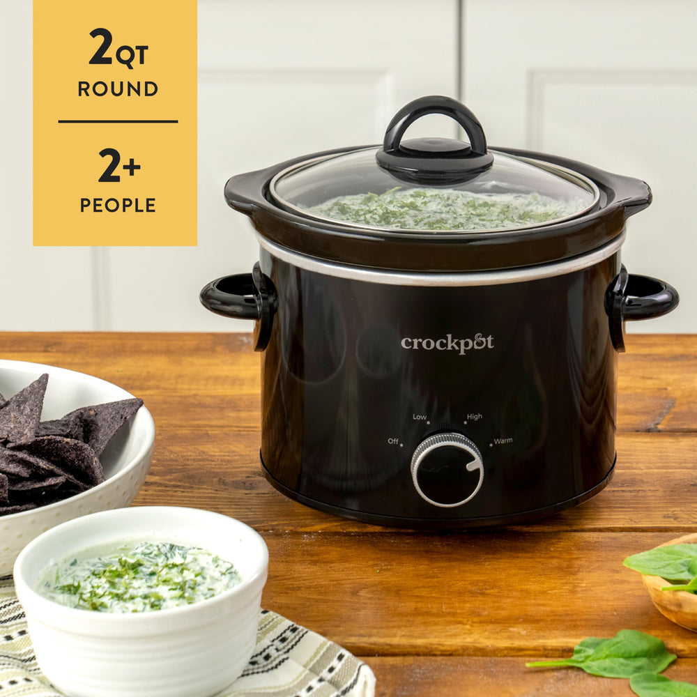 Crock-Pot next to a dinner plate showing scale, Crock-Pot brand compact size feeds two-plus people