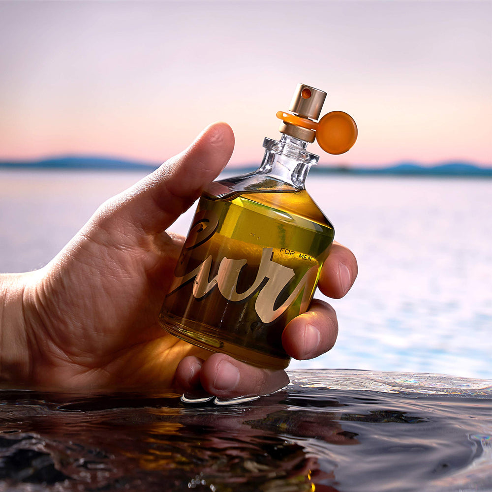 Bottle beside wrist for scale showing portable 4.2 fl oz convenience