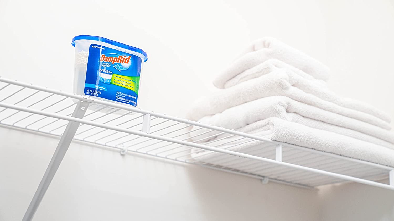 DampRid on closet shelf protecting clothes and linens from dampness