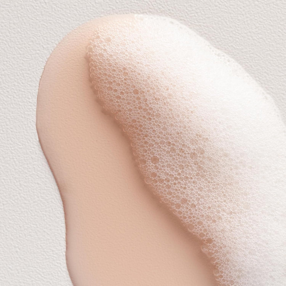 Applying Davines to scalp illustrating gentle massage to stimulate circulation and improve scalp balance