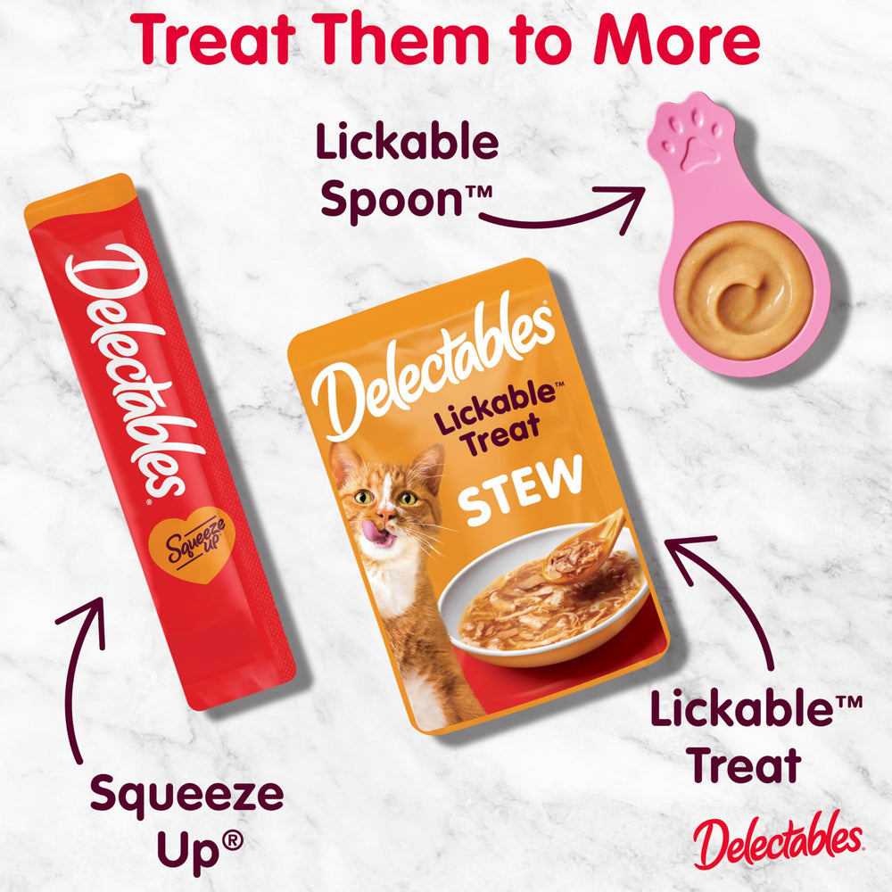 Delectables cat enjoying treat during petting to encourage bonding