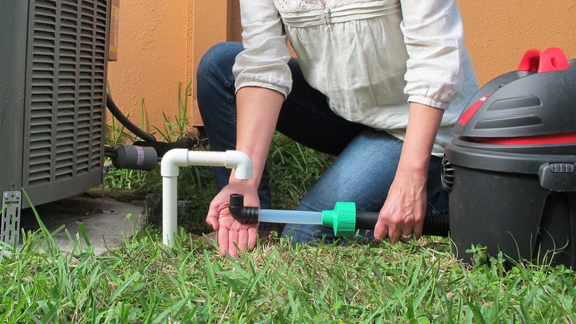 Diyvac attachment in use on AC drain showing efficient clog evacuation