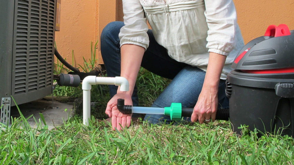 Diyvac attachment in use on AC drain showing efficient clog evacuation