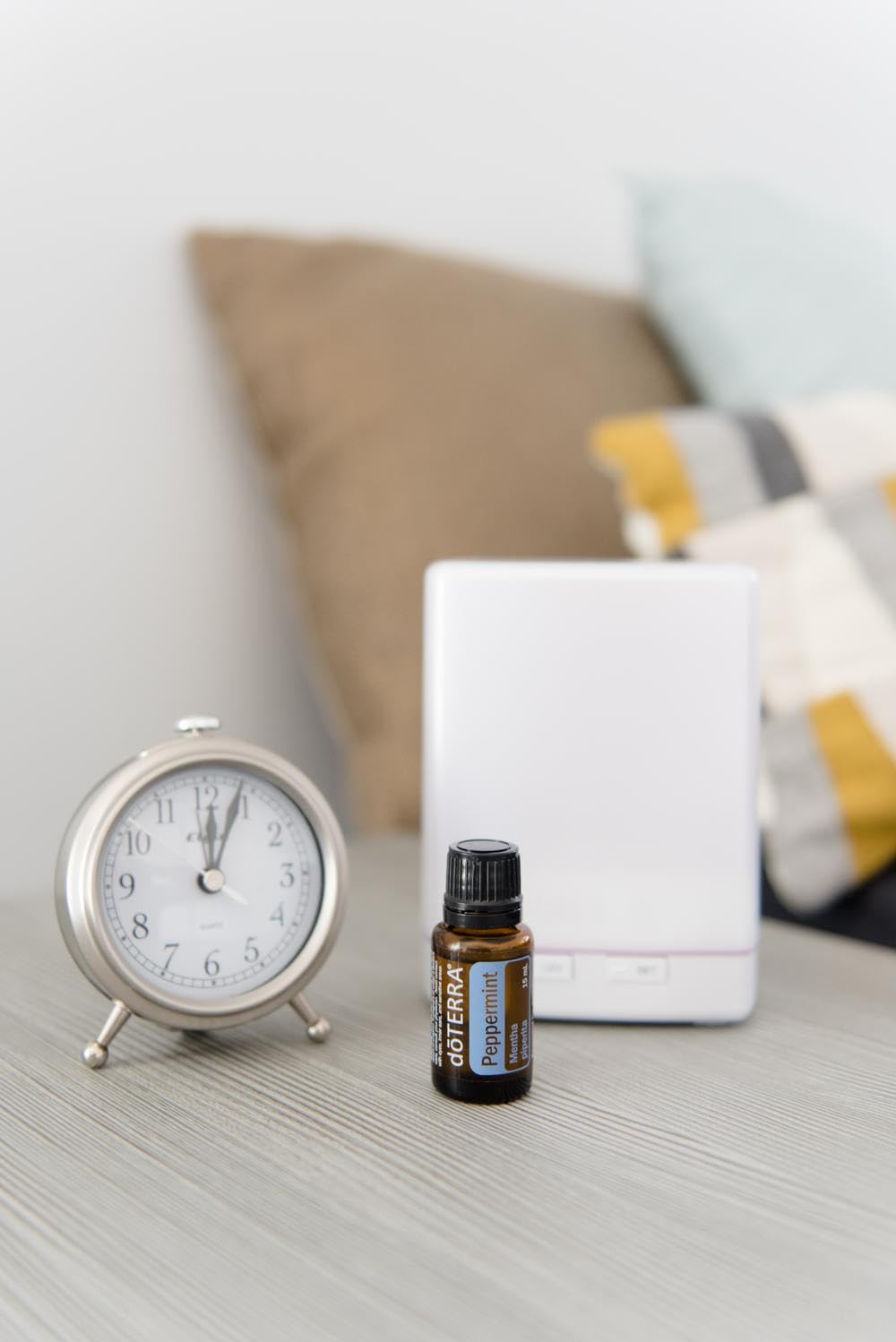doTERRA peppermint 15ml next to a coin for scale showing compact size and travel-friendly bottle