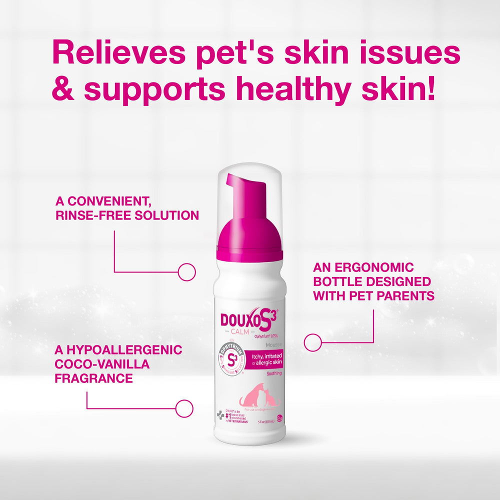 Douxo bottle held next to a hand showing compact travel-friendly size
