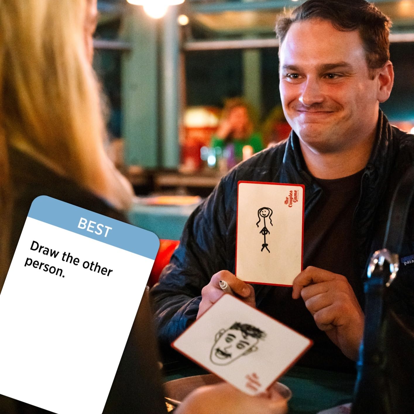 DSS Games next to a hand illustrating compact travel-friendly size
