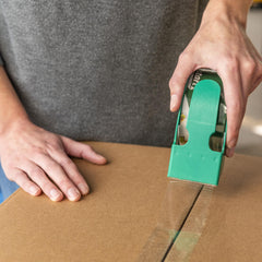 Duck tape installed in a dispenser demonstrating quiet, fast application benefit