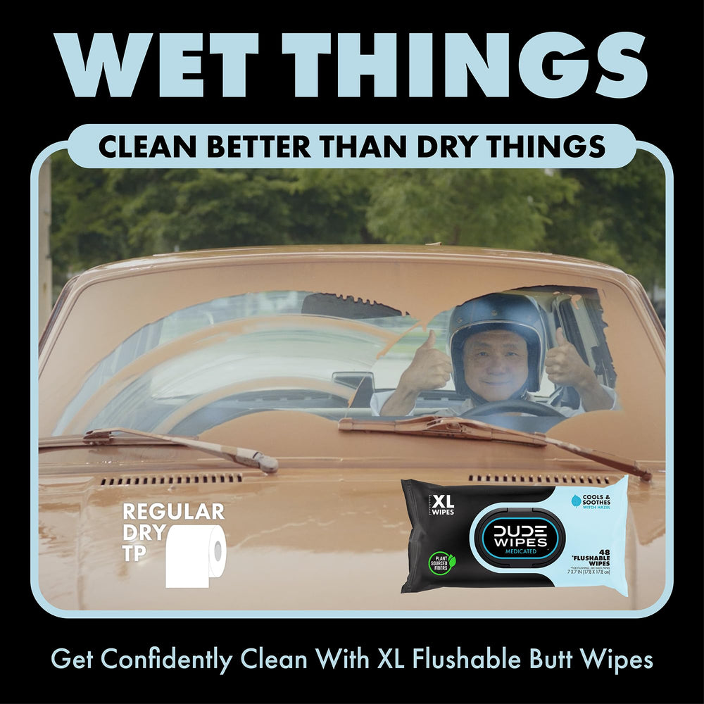 Bathroom countertop with DUDE Wipes dispenser placed beside toilet for convenience