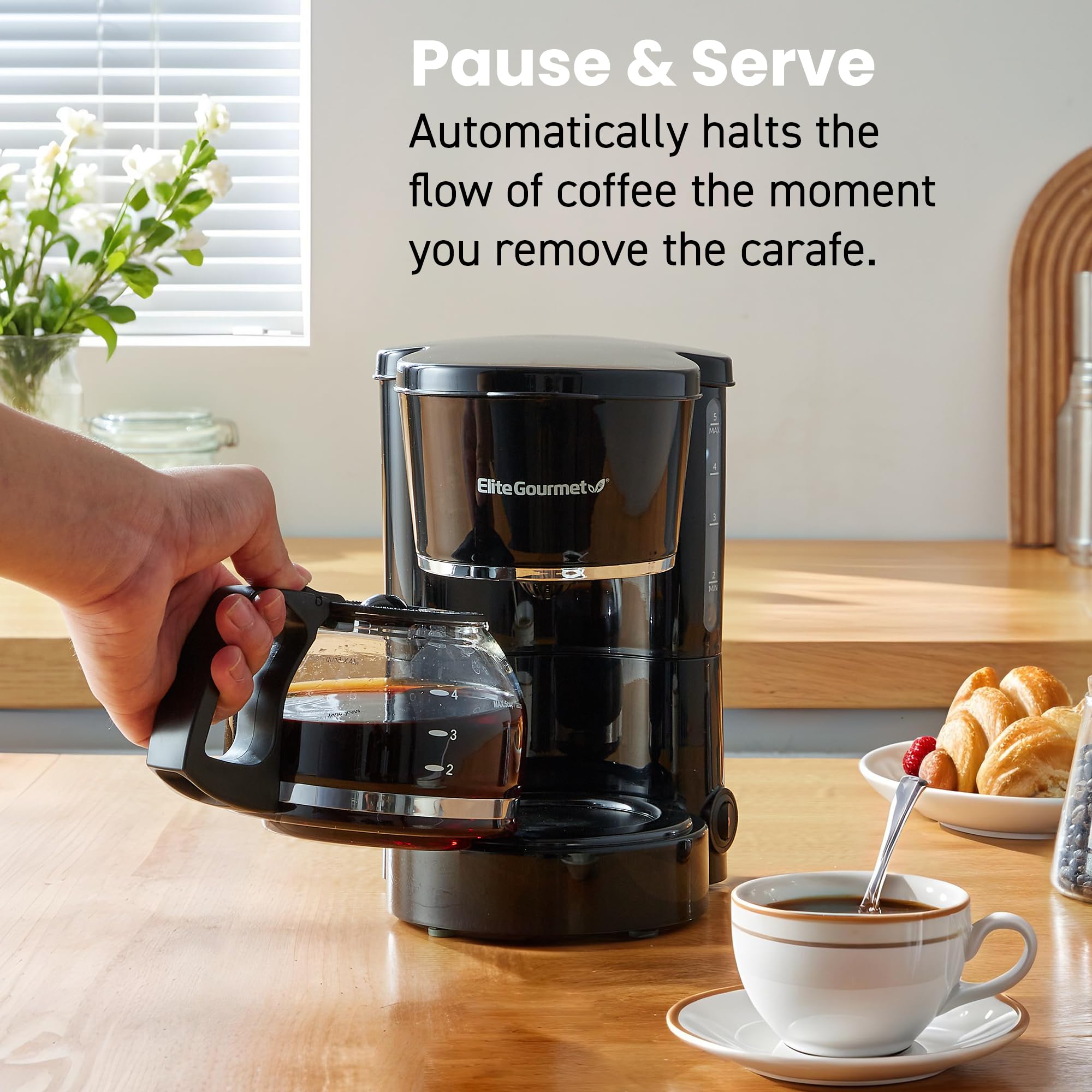 Elite Gourmet beside standard mug showing scale to judge footprint and portability benefit