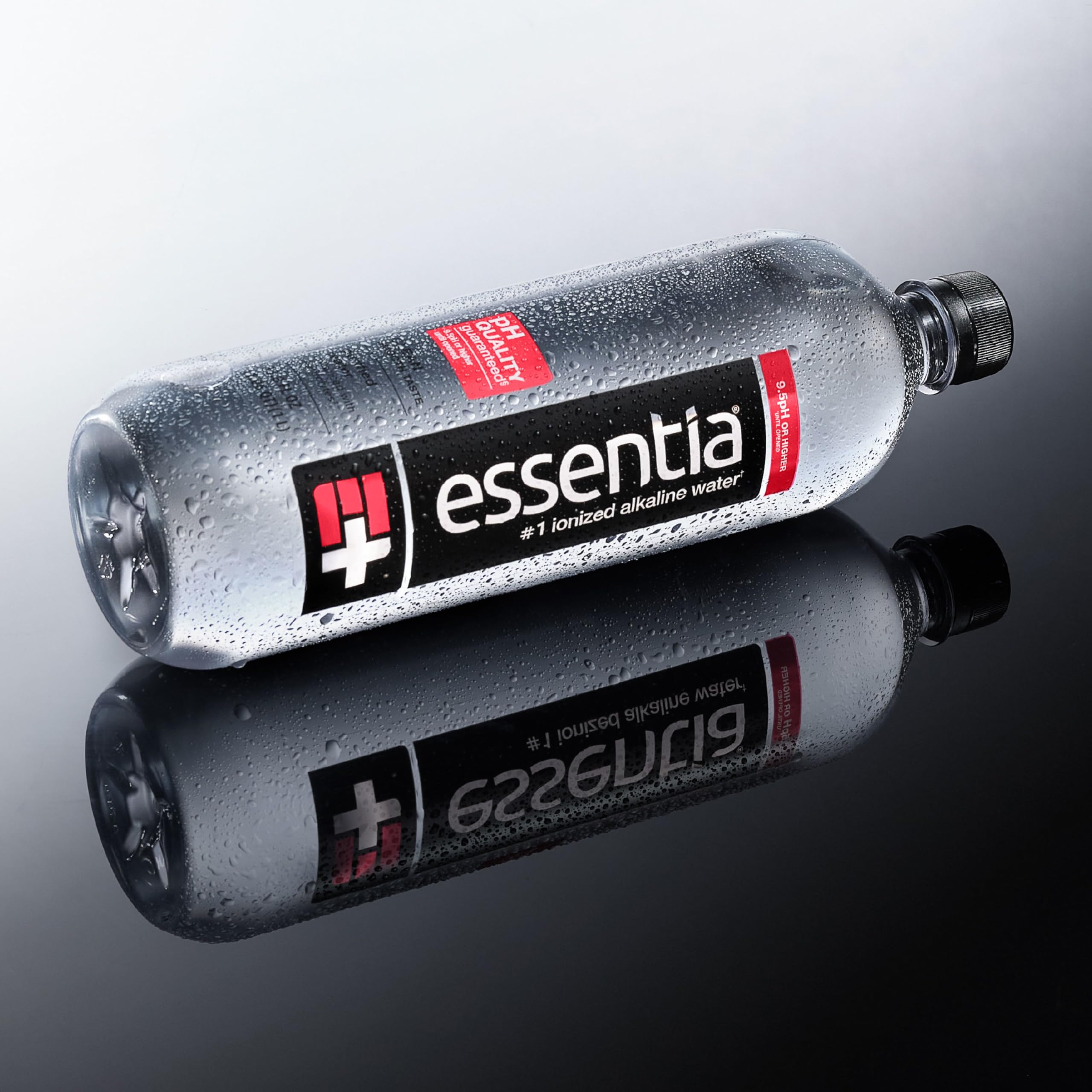 Essentia Water on desk beside laptop showing focused hydration support