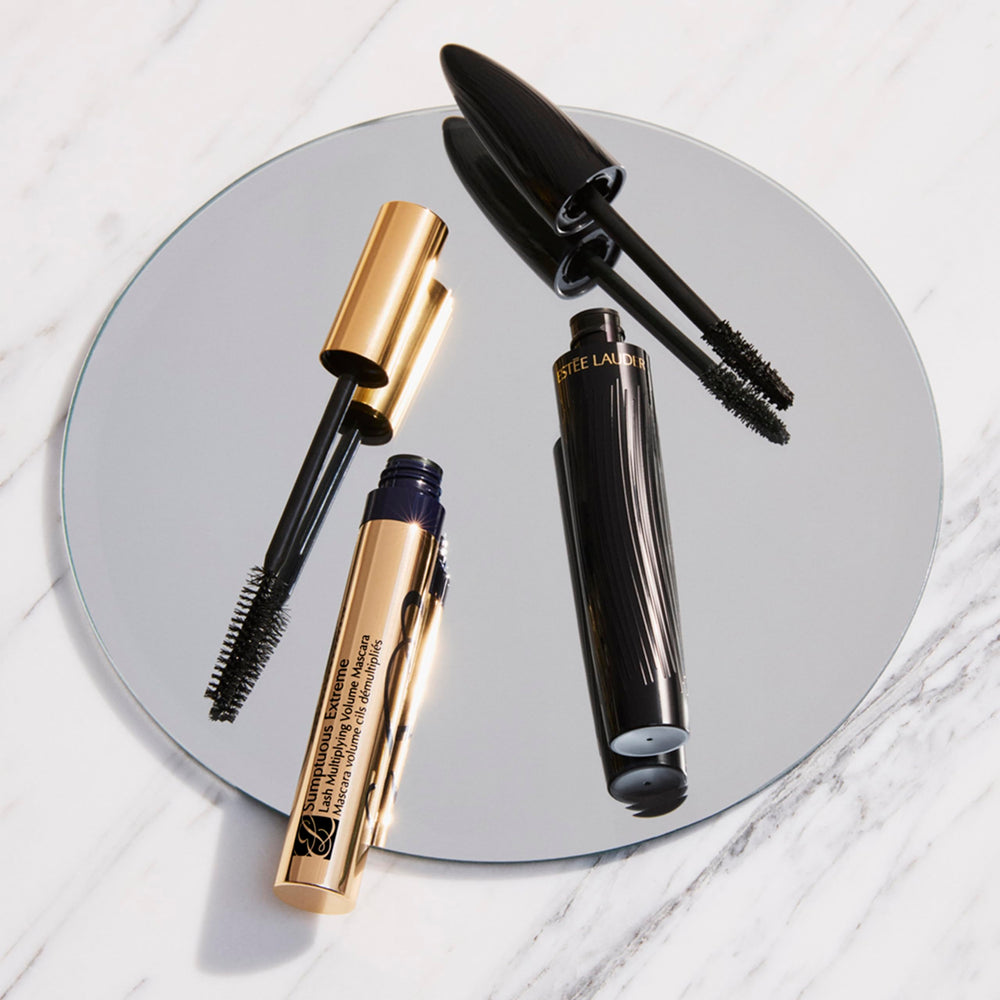 Estée Lauder mascara held in hand to show 0.27 fl oz scale and portability