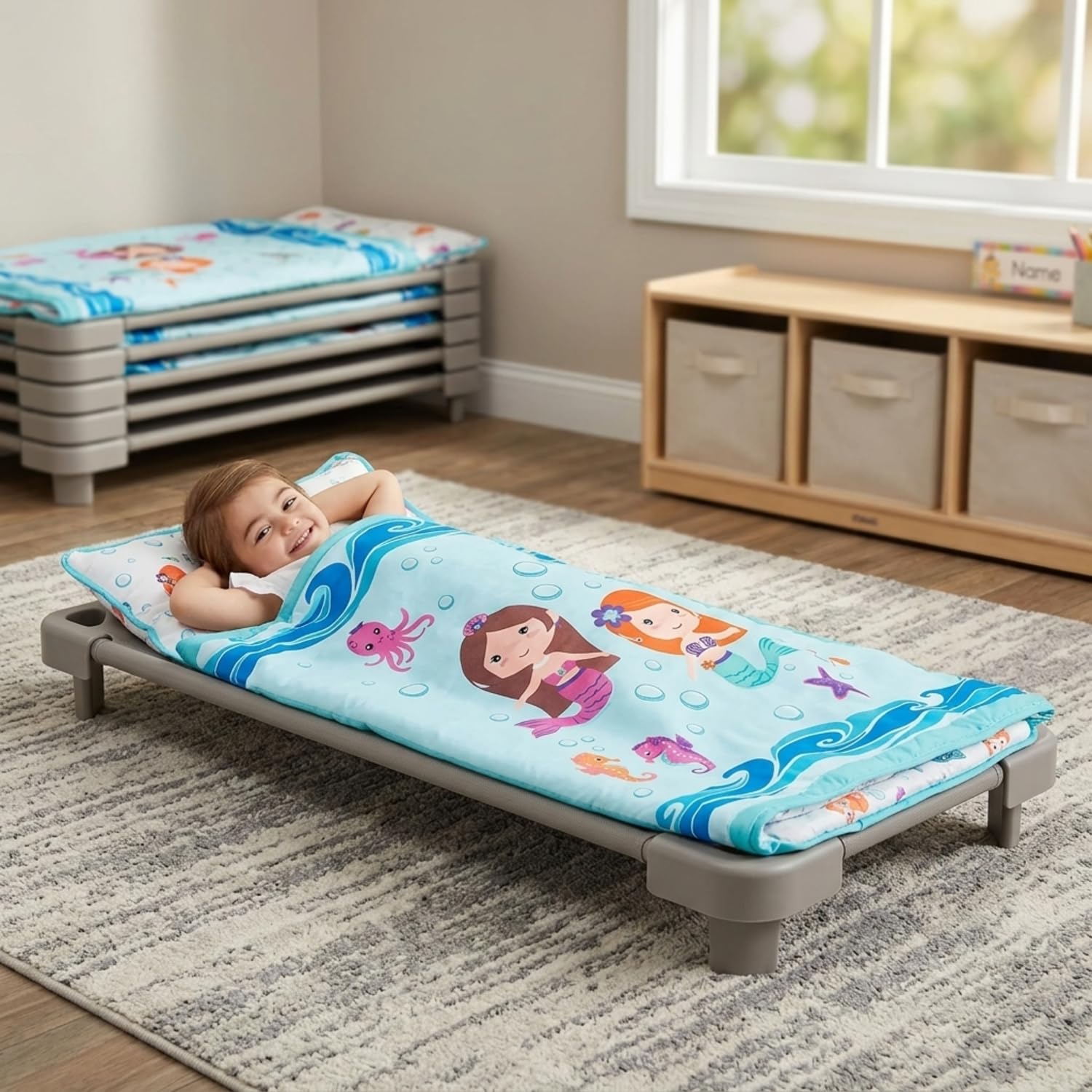 EVERYDAY KIDS rolled mat with fastening straps and handle showing compact transport benefit portability