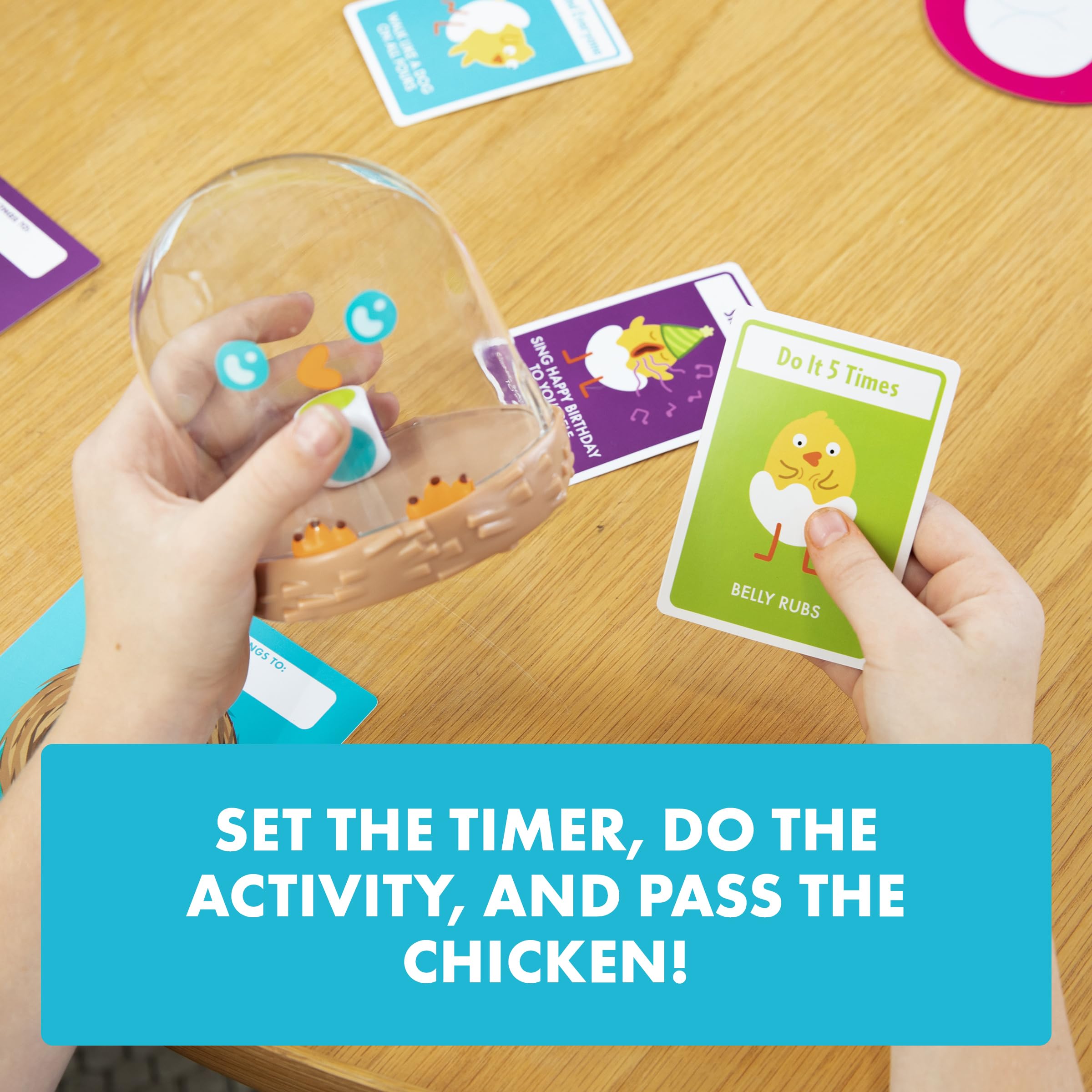Exploding Kittens chicken shaker in hand showing portable size and easy passability