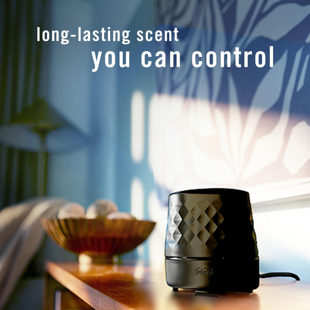 Febreze Plug Scent Booster with cord positioned on countertop for flexible placement and strong coverage