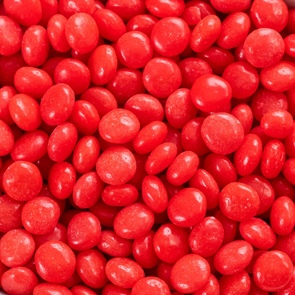 Ferrara Red Hots placed in a theater cupholder illustrating ideal movie snack