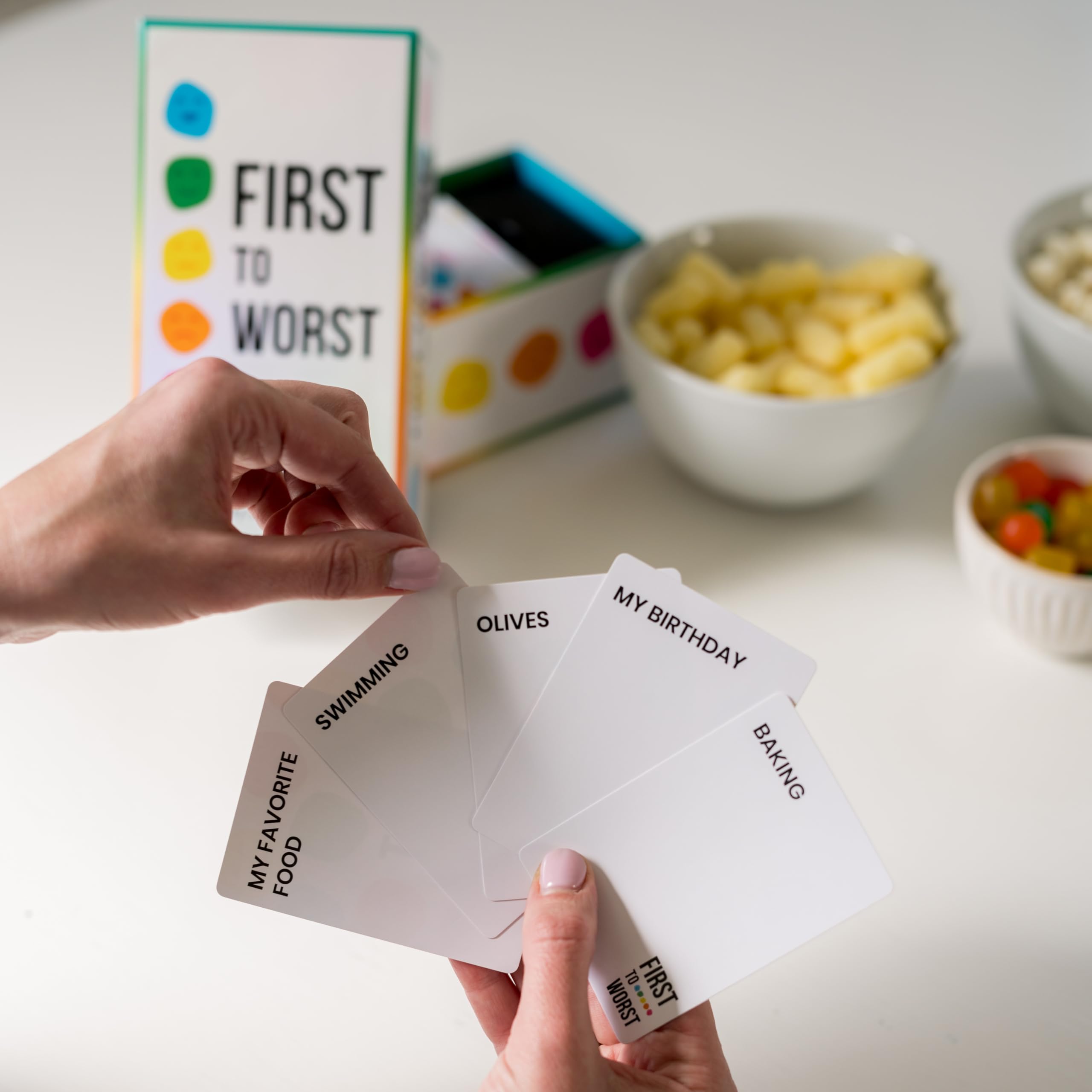 FIRST TO WORST cards laid out on table mid-round, demonstrating easy gameplay