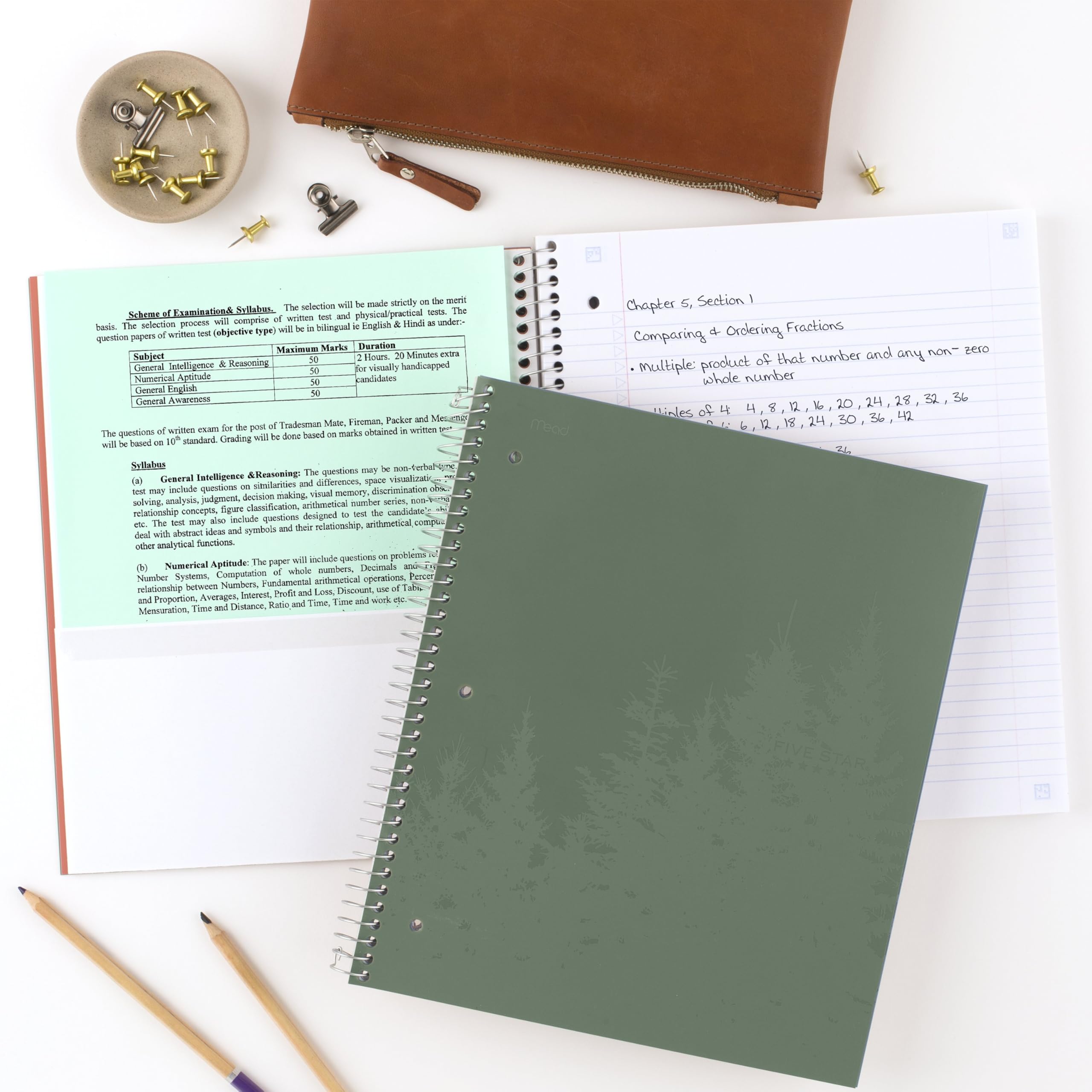 Five Star notebook held in hand to show 8.5x11 size and portability