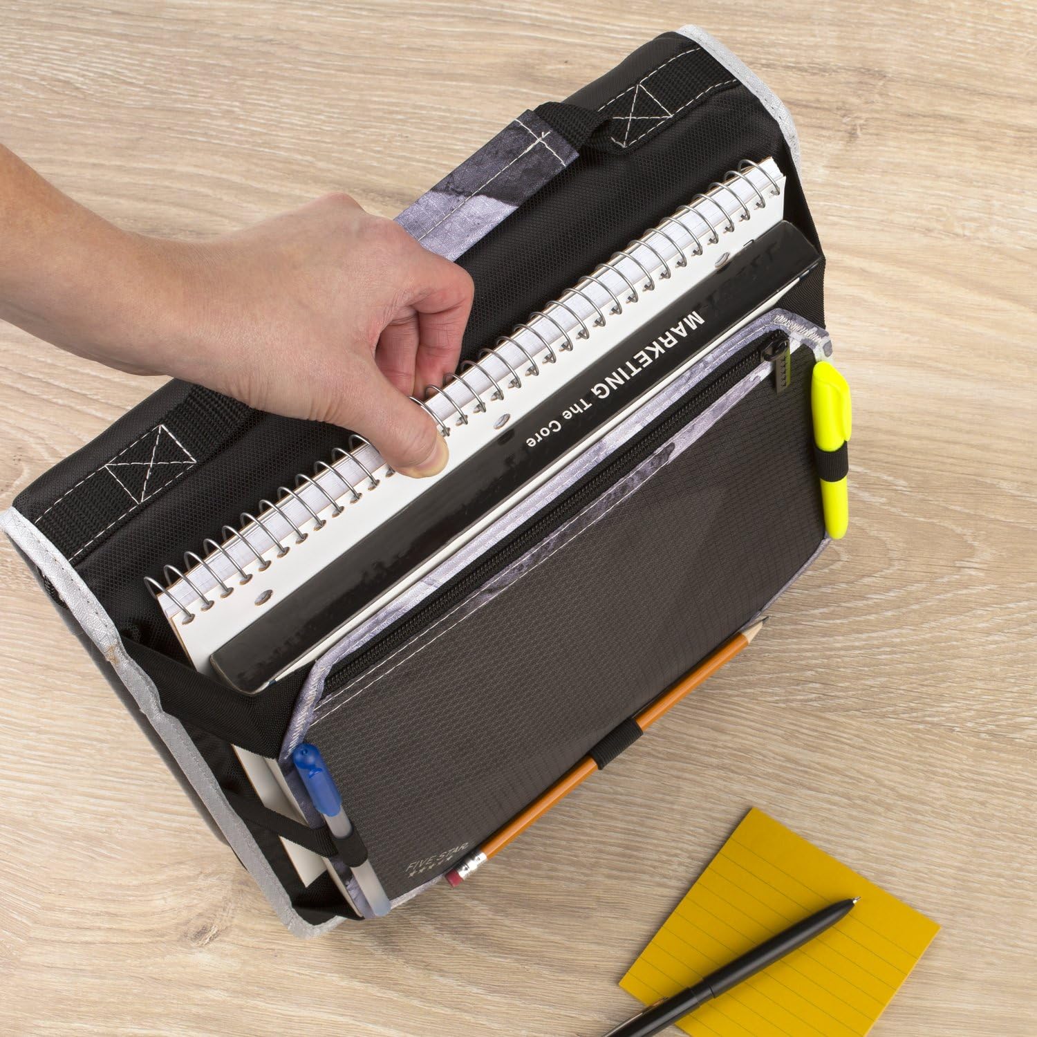 Five Star binder placed in backpack showing compact fit and easy portability