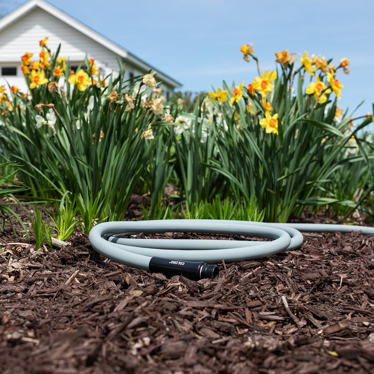 Flexzilla hose beside measuring tape showing true 50 ft. length and scale