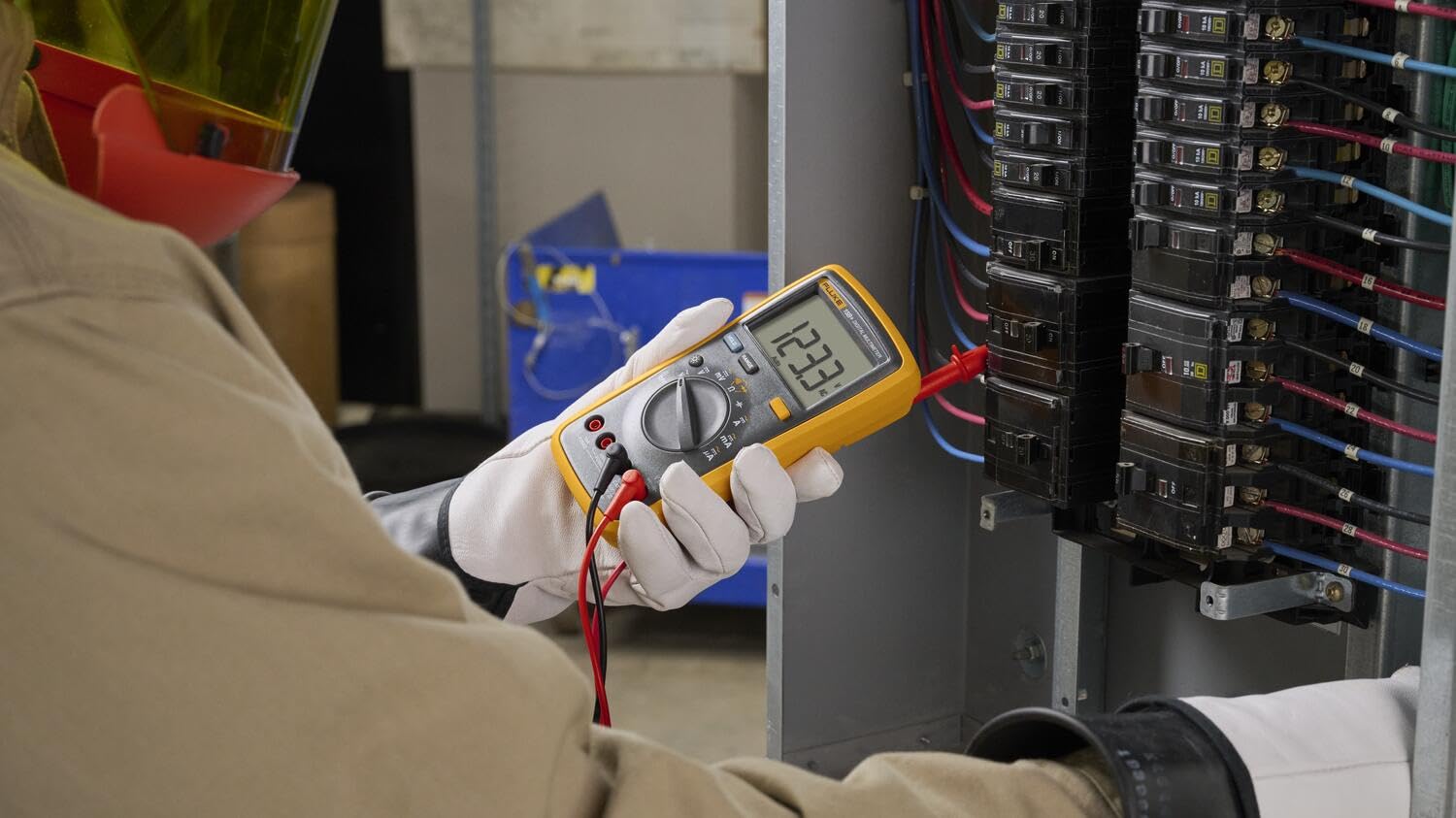 Fluke 15B+ next to a hand for scale showing compact portability advantage