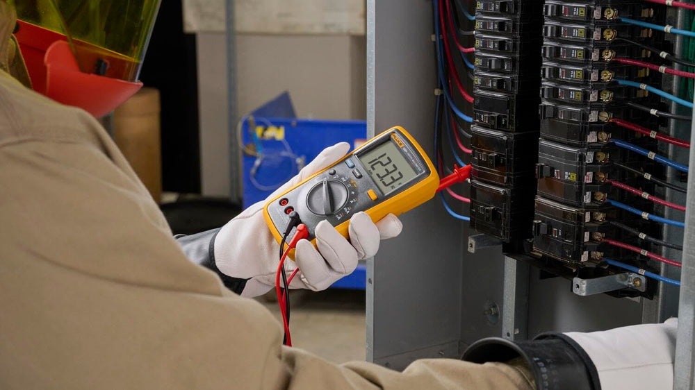 Fluke 15B+ next to a hand for scale showing compact portability advantage