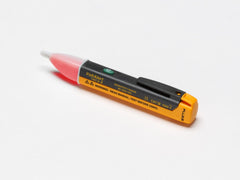 Fluke testing a wall outlet in use to quickly confirm live voltage presence