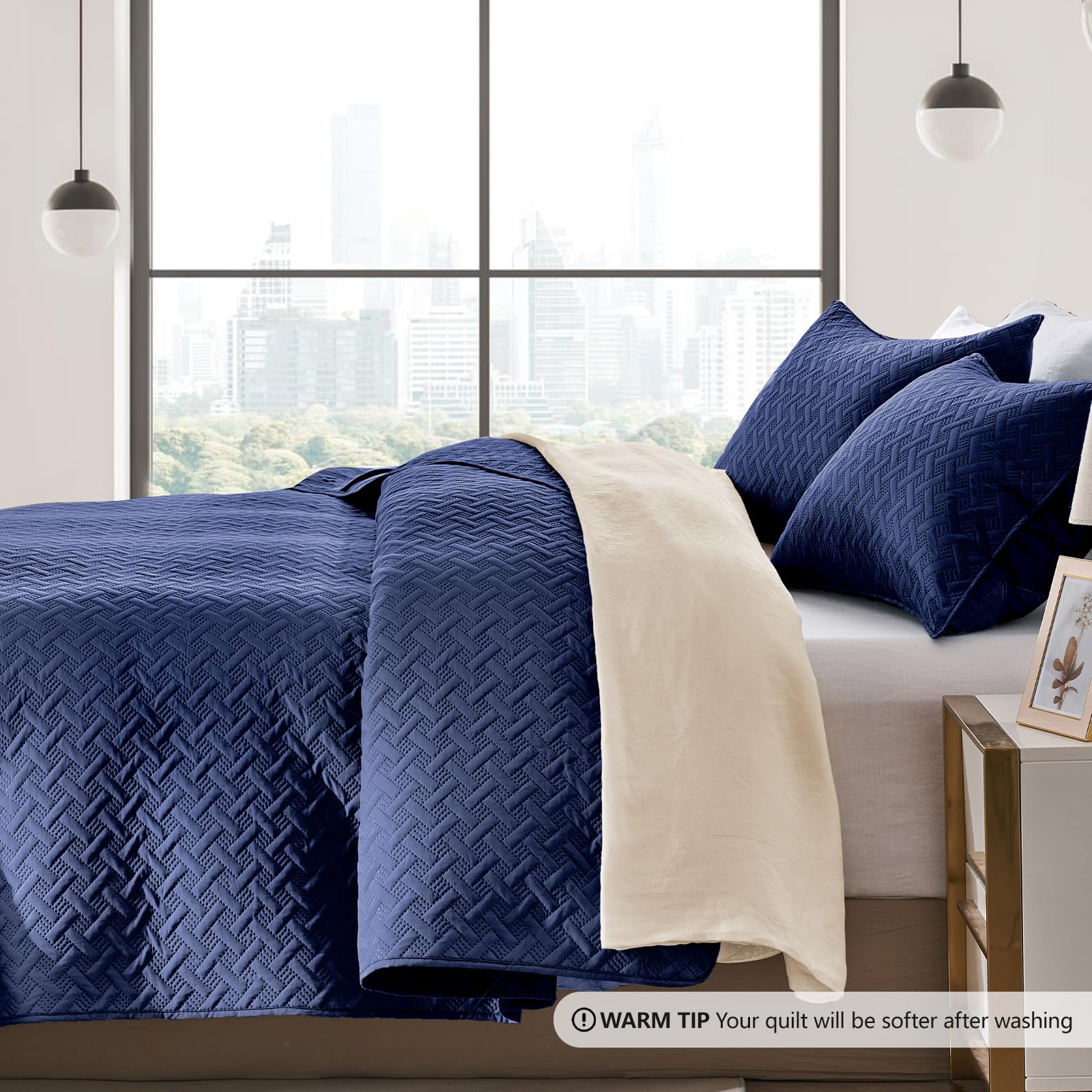 FLYMME quilt styled on a queen bed showing navy color and room upgrade