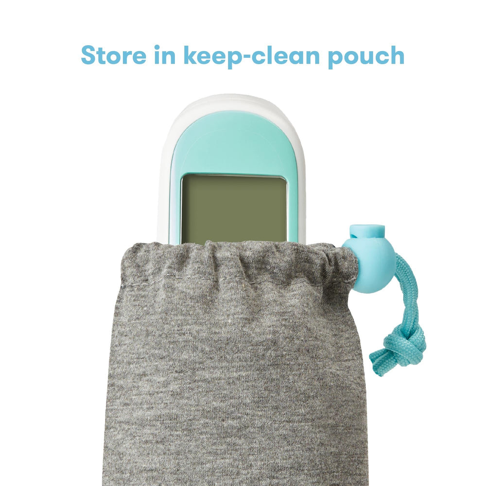 Frida Baby thermometer beside storage pouch showing compact travel size
