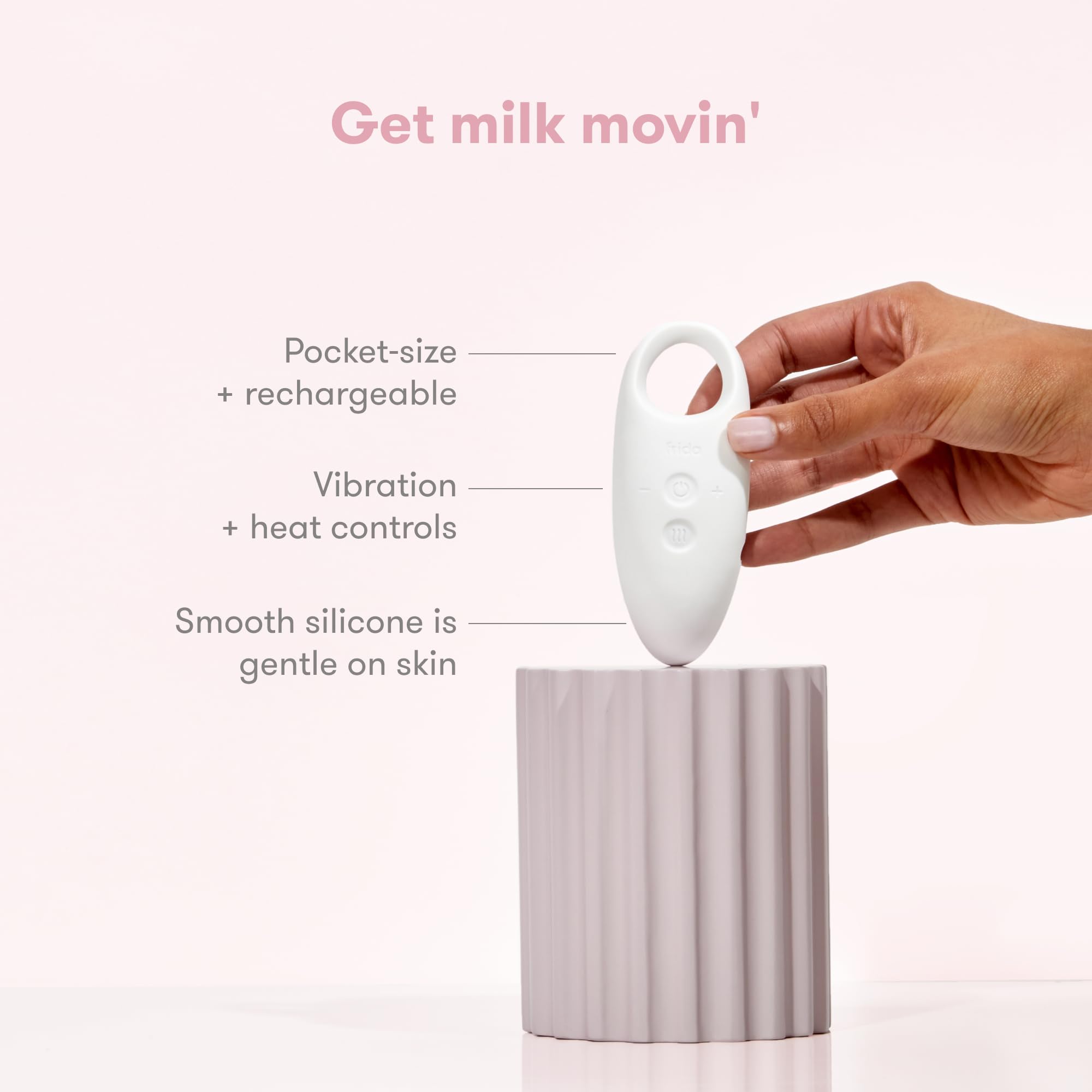 Frida Mom massager placed in a nursing bra for hands-free support while feeding, increases comfort
