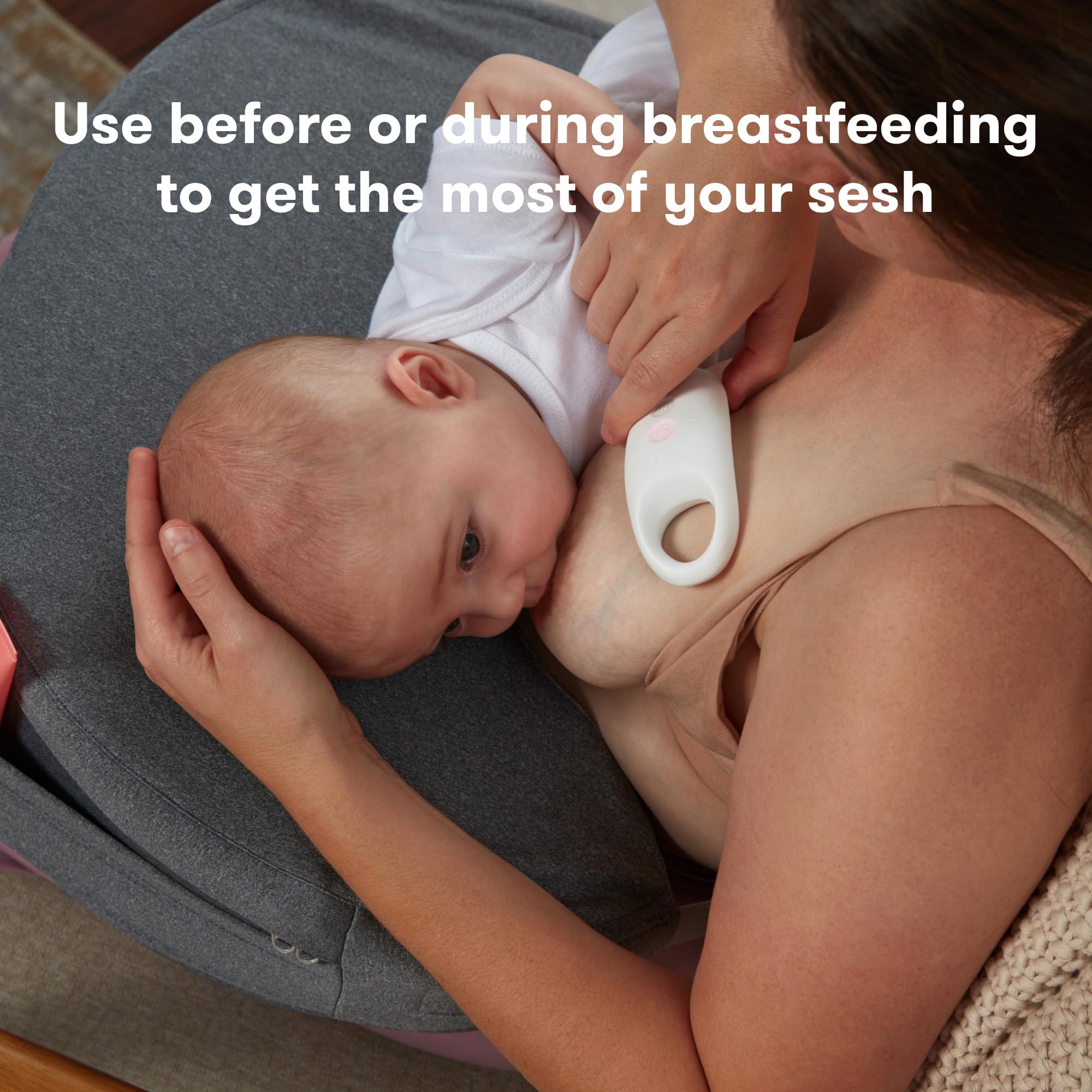 Frida Mom massager positioned above a breast pump flange to aid expression and help clear ducts
