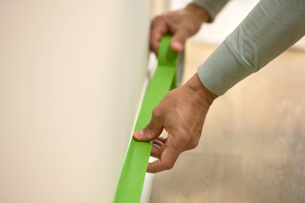 FrogTape being removed cleanly showing no residue for easy cleanup